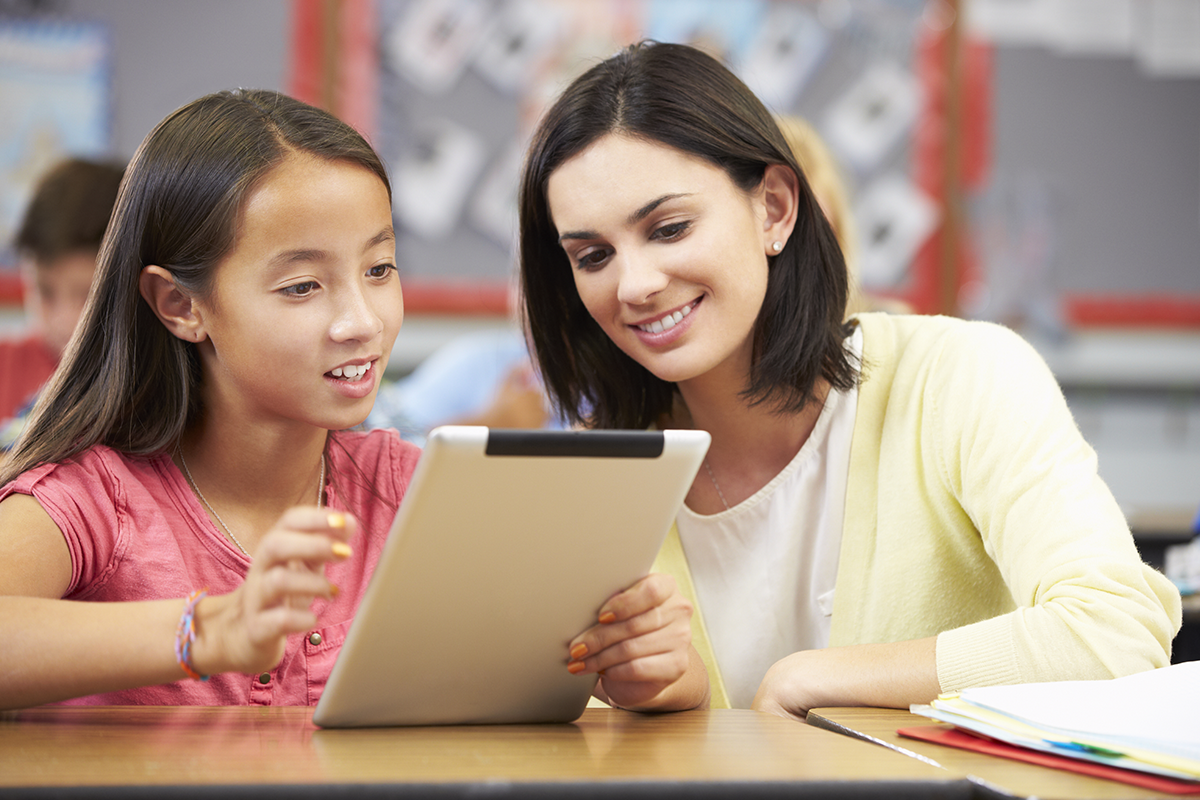 middle school student with teacher and iPad