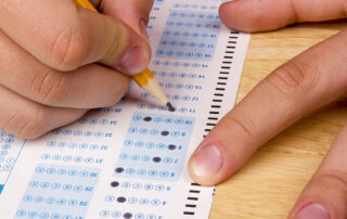 student bubbling in answer sheet for an ACT exam