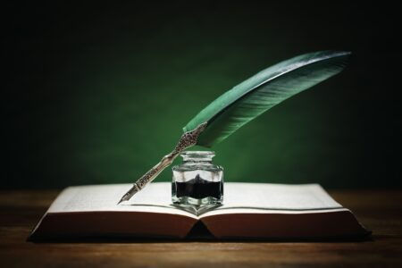 quill pen and inkwell on book of poetry to celebrate black history month