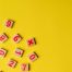 Making math fun! Wooden numbers on yellow background.