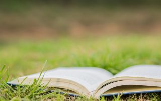 Environmental book open in a field of grass
