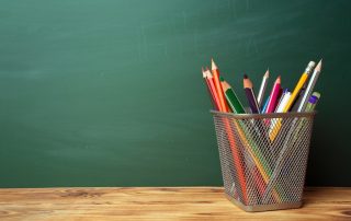 Last days of school, green chalkboard and colored pencils for coloring activities