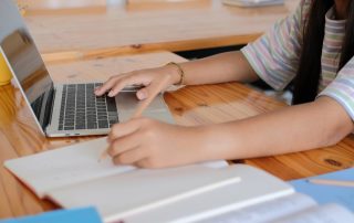 student studying for a test using digital and physical tools. test taking motivation